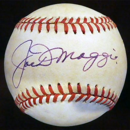 A slightly toned ball signed in an off blue to purple colored pen on the sweet spot. Signature is a 9/10 and ball is 6-7/10 due to even toning.