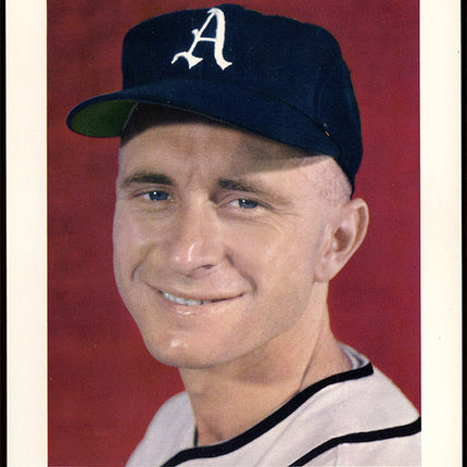 Baseball player Bobby Shantz wearing a cap with a logo on a red background