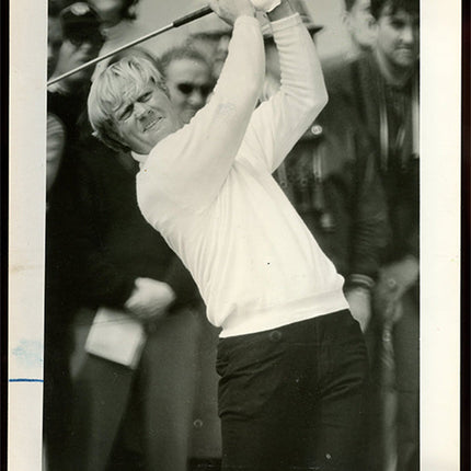 Black and white photograph of golfer Jack Nicklaus in action with spectators in the background