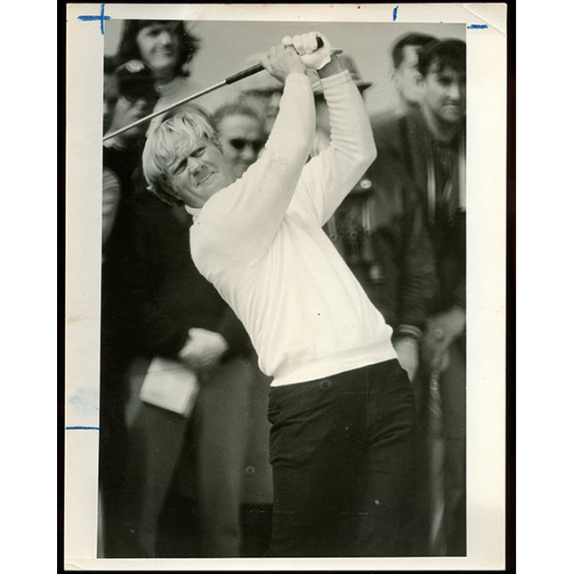 Black and white photograph of golfer Jack Nicklaus in action with spectators in the background