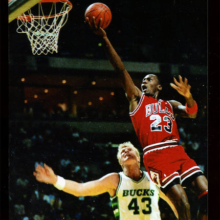 Image of a finger roll by Michael Jordan from the mid 1980's with Jack Sikma in image.