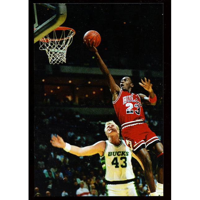 Image of a finger roll by Michael Jordan from the mid 1980's with Jack Sikma in image.