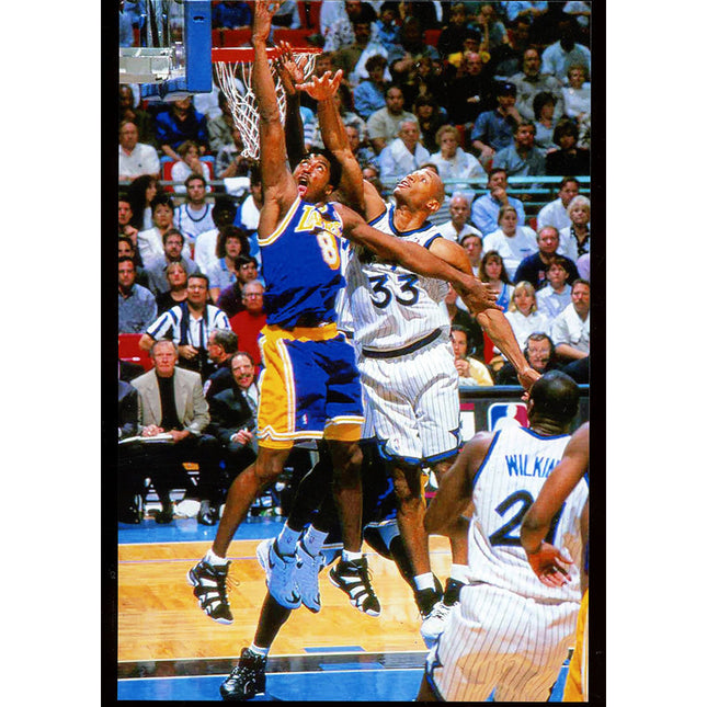 Color image of LA Lakers Kobe Bryant going up with Orlando Magic Derek Stroing.