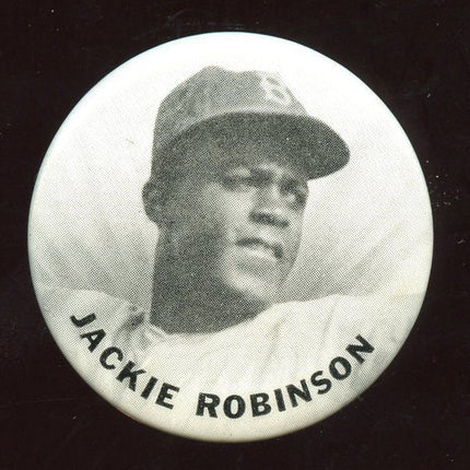 1950's Jackie Robinson PM10 Pin. Circular button badge with a black and white photo of a baseball player and 'Jackie Robinson' text.