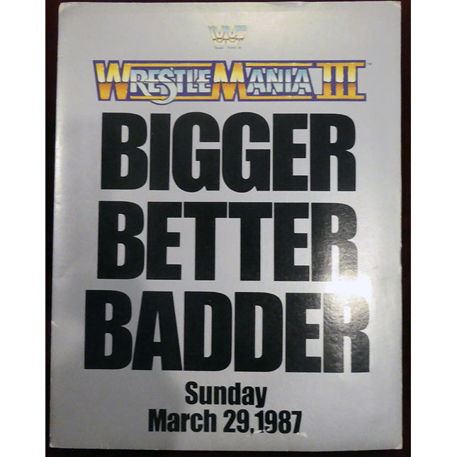 Promotional kit for WrestleMania III with text 'Bigger Better Badder' and event details.