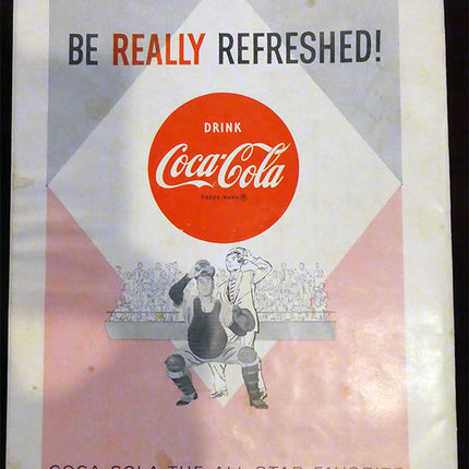 Vintage Coca-Cola advertisement with two people and a sports theme.